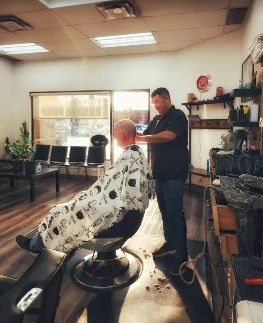 Barber cutting a customer's hair at Willow Road Barber Shop in Guelph