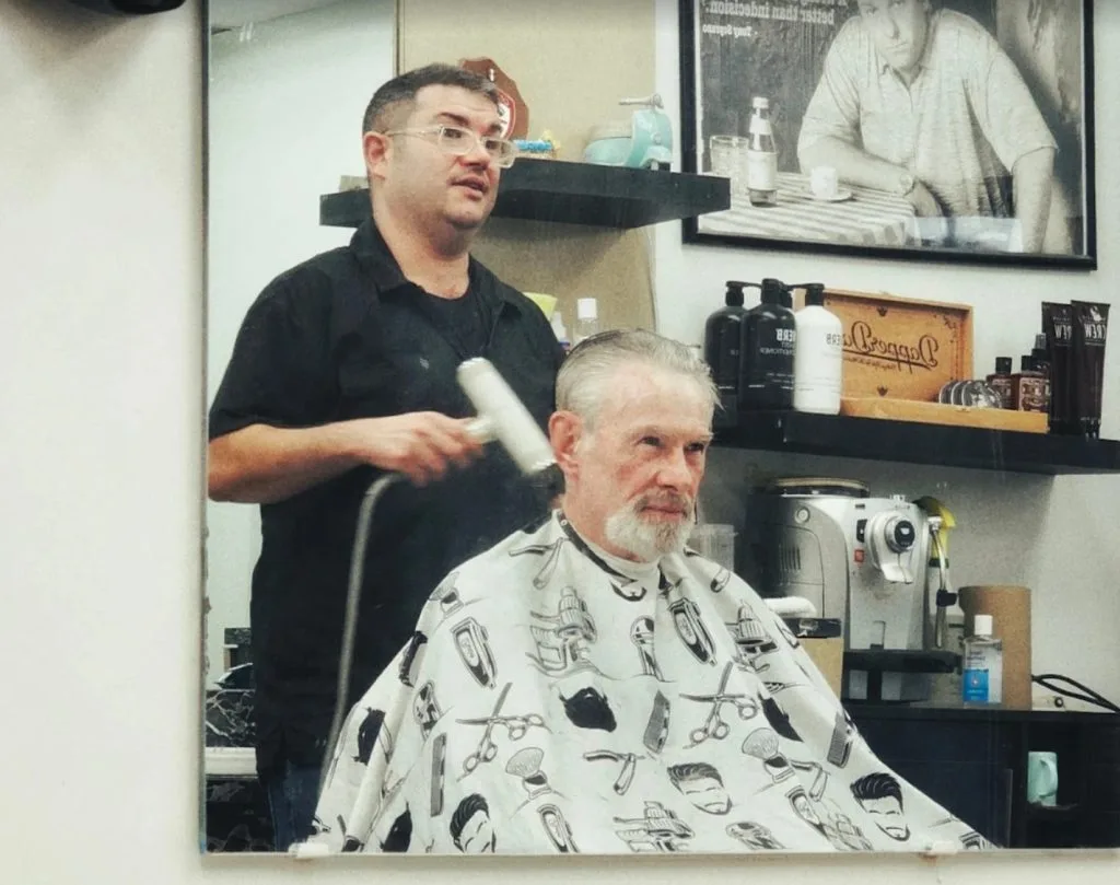 Ricky the barber at work at Willow Road Barber Shop in Guelph